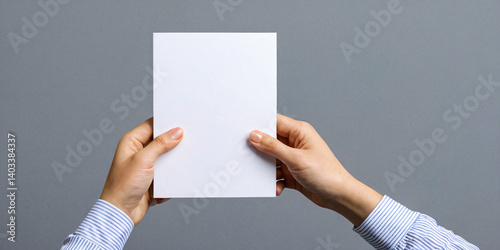 Wallpaper Mural Hand holding a white sheet of paper on a gray background. Torontodigital.ca