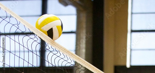 volleyball going over the top of the net