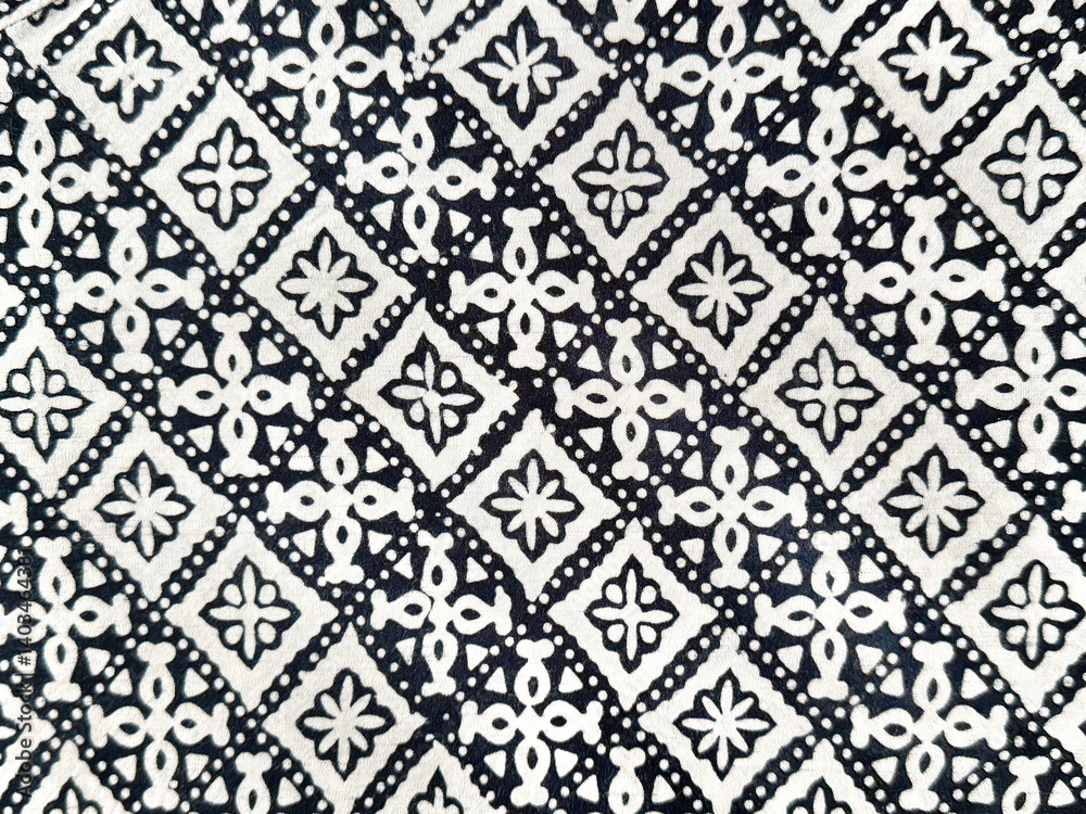 Fototapeta premium Traditional graphic background in random abstract ornamental floral and diamond pattern. Black and white ethnic lace and cloth. Seamless background texture. Indonesian batik