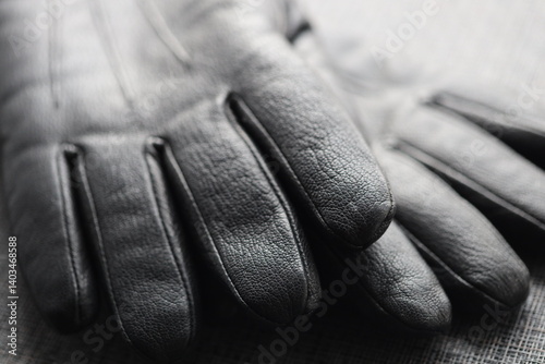 A classic pair of black and white leather gloves, great for formal events or as a prop.