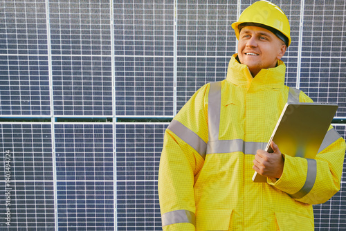 Solar technician on the roof with solar panel array