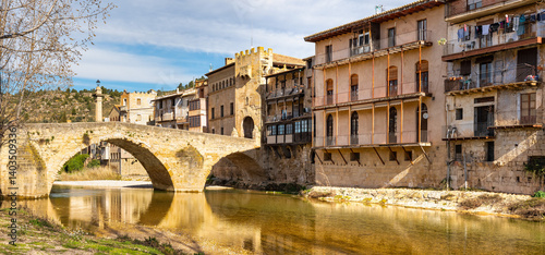 Obraz na płótnie Medieval stone bridge across the river that passes by the medieval town of Valderrobres, Teruel, Spain. w salonie