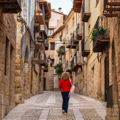 Tourist woman enjoying the charming medieval streets of the village of Valderrobres, Teruel, Aragon.