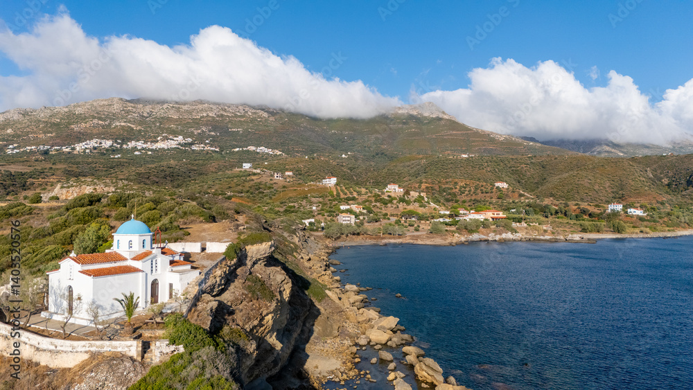 Fototapeta premium Scenic coastal view capturing a peninsula with rocky shores and serene blue waters under a partly cloudy sky - Ammitsa beach, Neapoli Lakonia