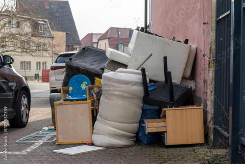 Pile of bulky waste with furniture at the side of the road