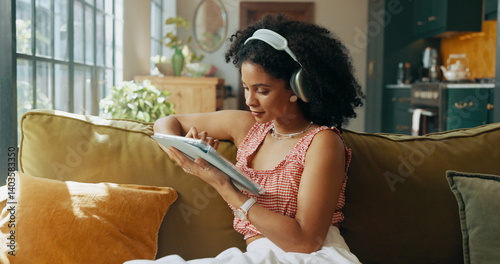 Tablet, headphones and woman on sofa for music, streaming song or audiobook in home. Living room, technology and African person listening to radio, podcast and sound for playlist on internet to relax
