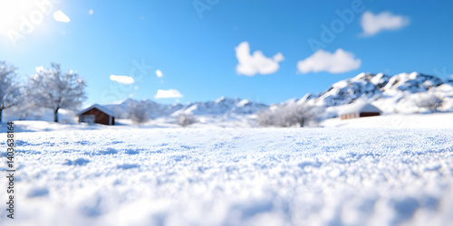 Snowy Winter Landscape with Mountains and Wooden Houses Under a Sunny Sky