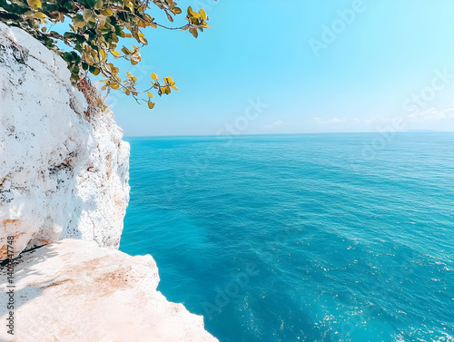 Turquoise Ocean Waters and Rocky Coastline with Vibrant Vegetation Under Clear Blue Sky on Sunny Day