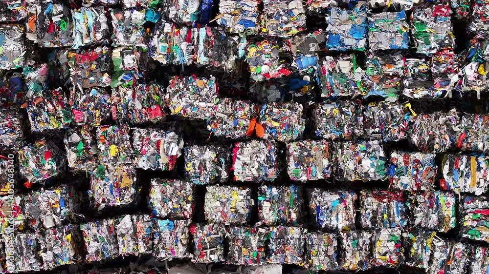 Recycling process of compressed plastic bales at a waste management facility