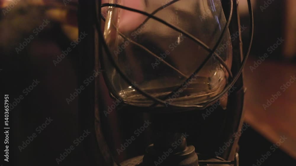 vintage man lighting an oil lamp in a dark room