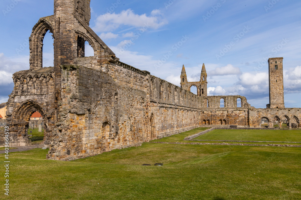 Fototapeta premium The ruins of St Andrews Cathedral overlook the sea, surrounded by ancient tombs and old stone walls. A peaceful, sacred place filled with religious history and timeless beauty. Endless architecture.