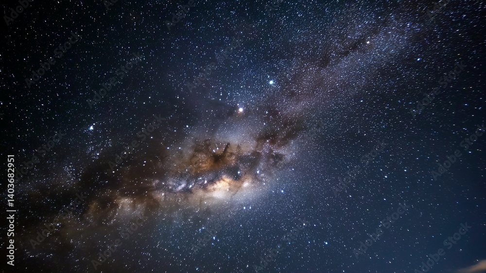 Fototapeta premium A breathtaking starry sky, with countless twinkling stars scattered across the dark canvas of the night, possibly with a faint glow of the Milky Way.