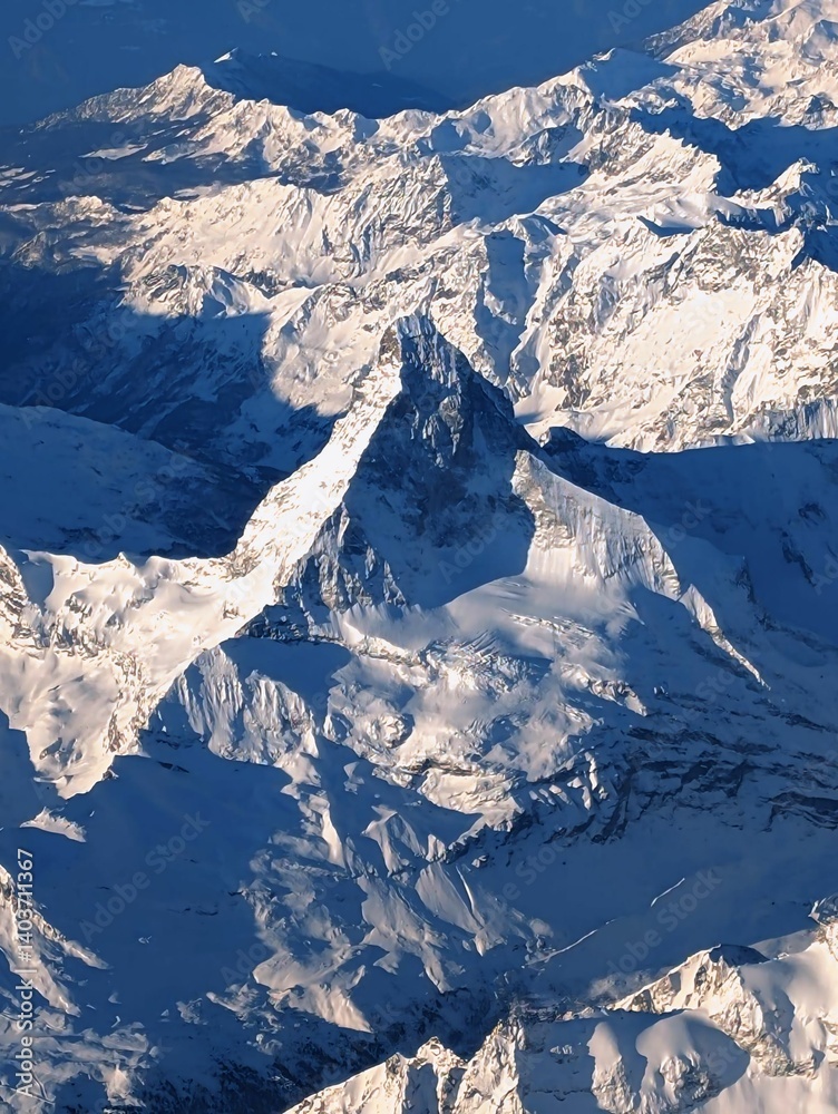Aerial view of the Swiss Alps in winter with snow covered peaks