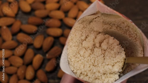 Scoop almond flour from a packet with a spoon. Ingredients for bakery gluten free