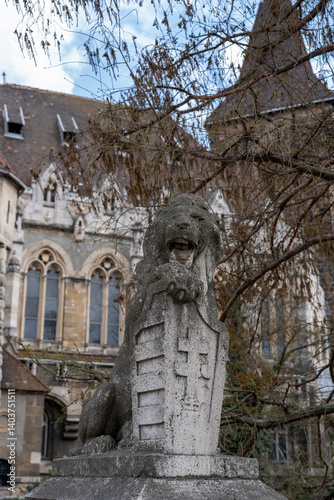 Stone lion statue with shield on gate of Vajdahunyad Castle is castle in City Park, Budapest, Hungary, Europe. Museum of Hungarian Agriculture