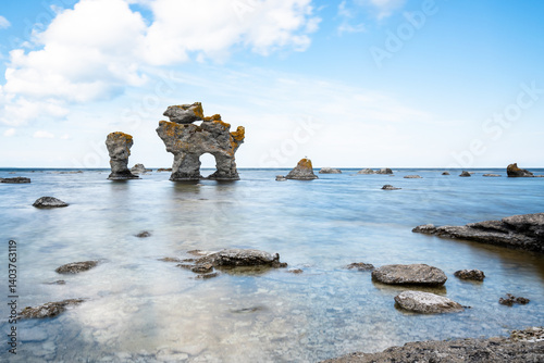 Limestone rocks formation raukar long exposure water reflection blurred clouds stones Baltic Sea Gotland Fårö island Sweden 