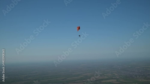 Wallpaper Mural Paraglider with orange wing soaring against clear blue sky backdrop Torontodigital.ca