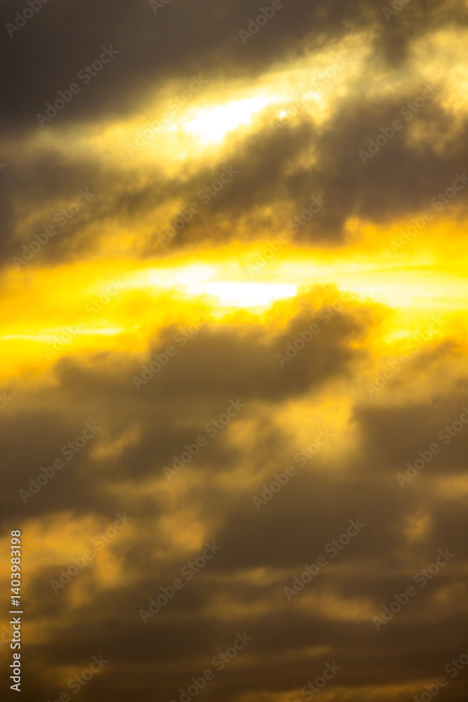 A stunning blend of yellow and gray clouds during sunrise, evoking feelings of calm and inspiration.
