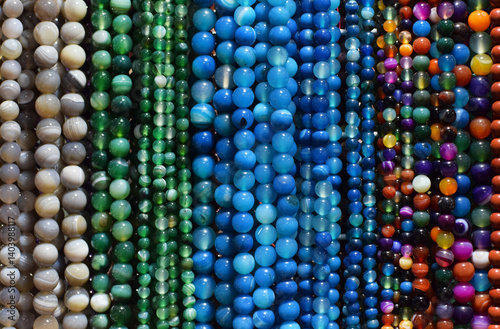 Strands of colorful natural agate beads at the gemstone market.