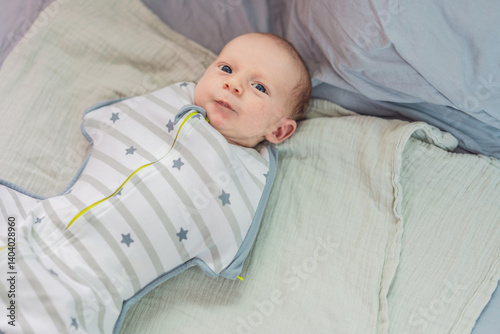 Obraz na płótnie A newborn baby rests snugly in a cozy sleep cocoon, feeling secure and comforted before drifting off to sleep. A peaceful moment of relaxation, warmth, and gentle care, symbolizing restful sleep and w salonie
