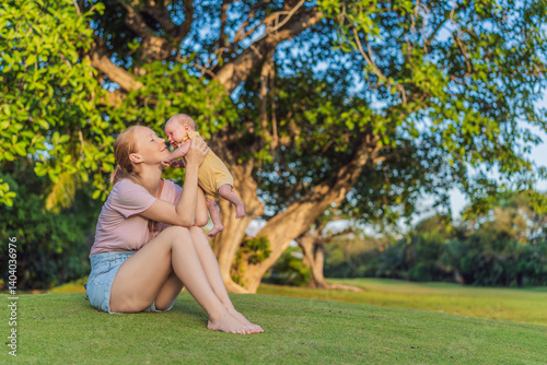 Young mother enjoying a peaceful walk in the park with her one-month-old baby. Motherhood, bonding, and outdoor family time concept