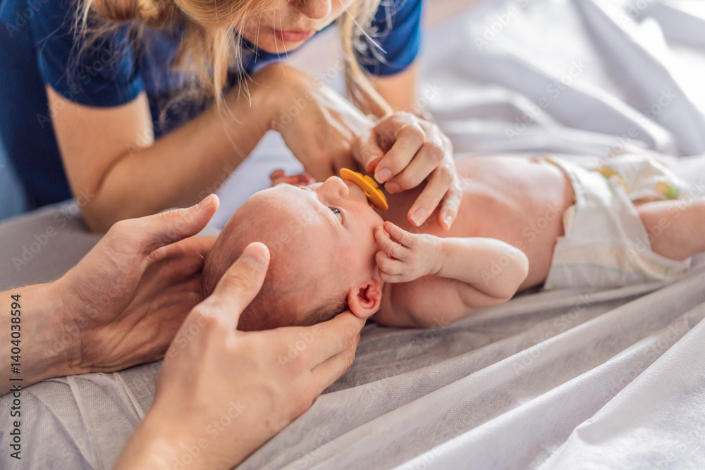 A newborn baby receives gentle osteopathic care, lying calmly while the specialist carefully examines and adjusts the infant. A moment of professional pediatric care, early development, and holistic