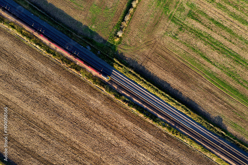 Fényképezés Aerial View of Railway Line Cutting Through Farmland – Train Tracks and Agricult