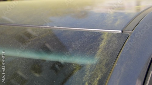 Birch pollen on a car. Birch pollen covered the surface of a car.