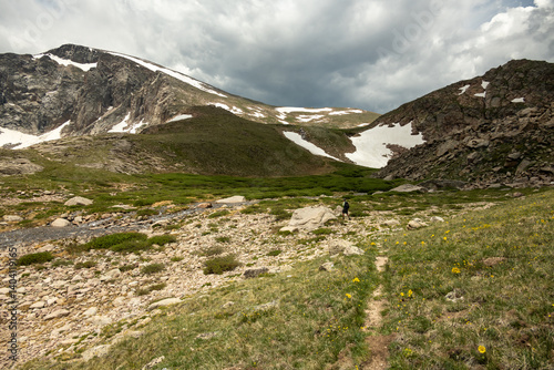 Hiker Crosses Rocky Creek Bed Near The Saddle In Rocky Mountain