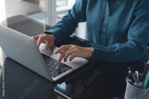 Photography Businesswoman working on laptop computer at modern office