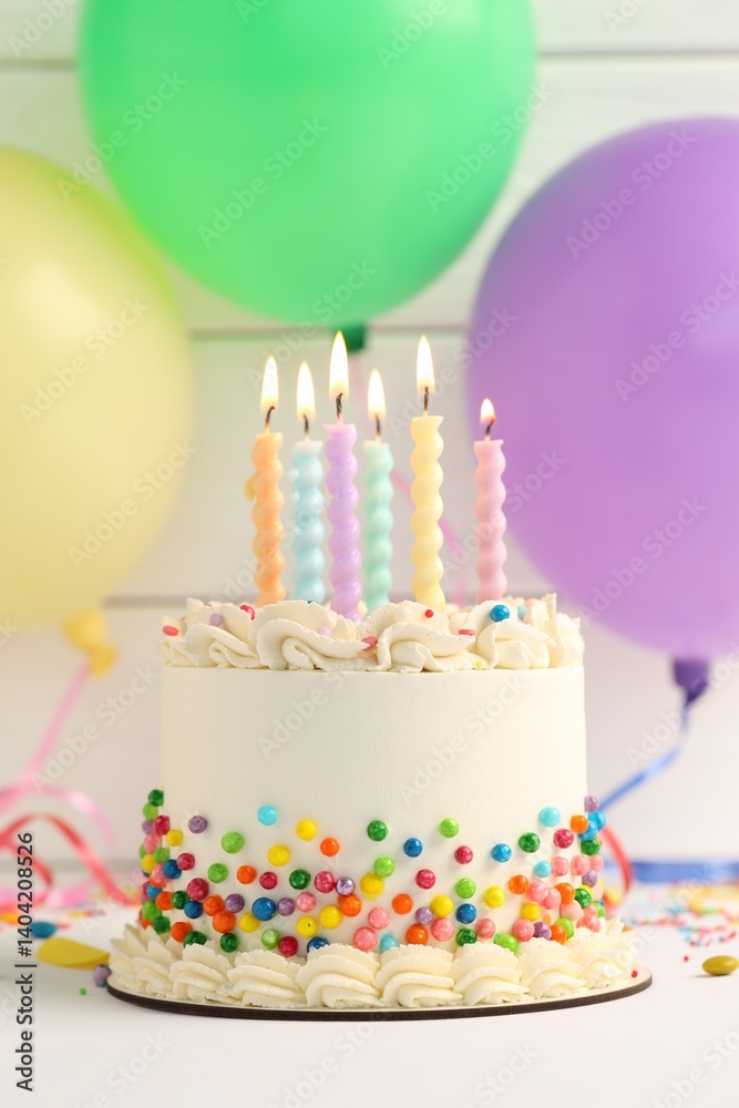 Delicious bento cake with colorful sprinkles and burning candles on white table Delicious bento cake with colorful sprinkles and burning candles on white table