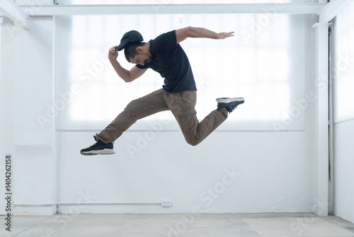 cool looking dancer makes a difficult jump. High quality photo