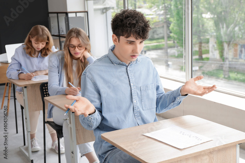Upset male student with res...