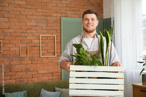 Young male gardener with pl...