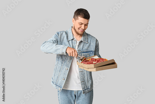 Happy young man in denim ja...