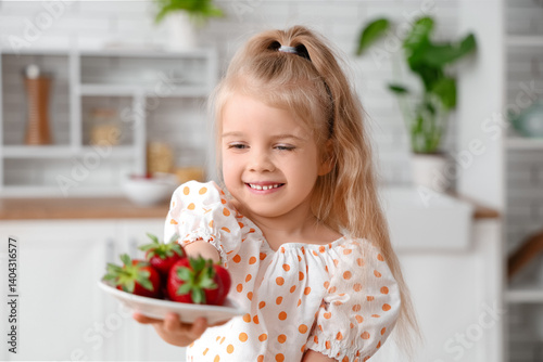Little girl holding plate o...