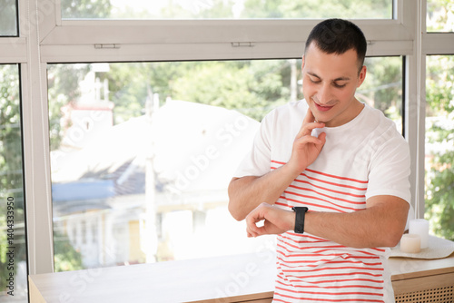 Young man with smartwatch c...