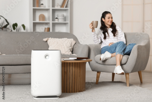 Modern air purifier on floo...