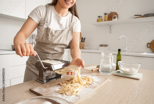 Young woman making pasta wi...