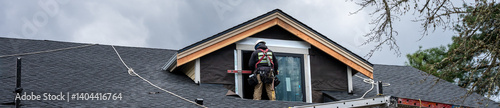 Wallpaper Mural New home construction site, carpenter on roof working on installing wood siding on house gable, residential housing development
 Torontodigital.ca