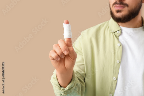Young man with bandaged fin...