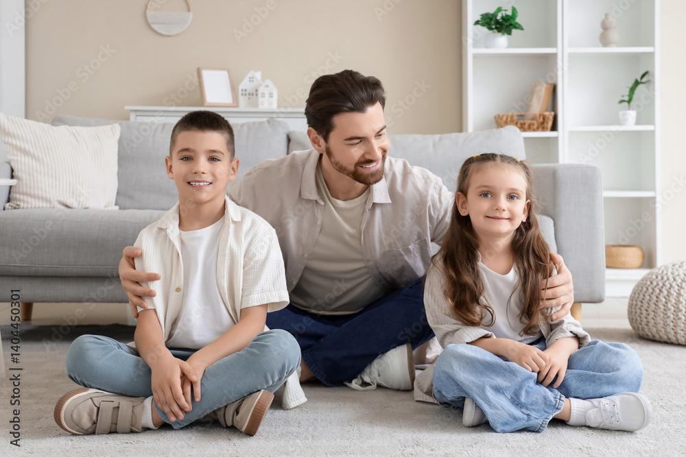 Happy father hugging his little children at home Happy father hugging his little children at home