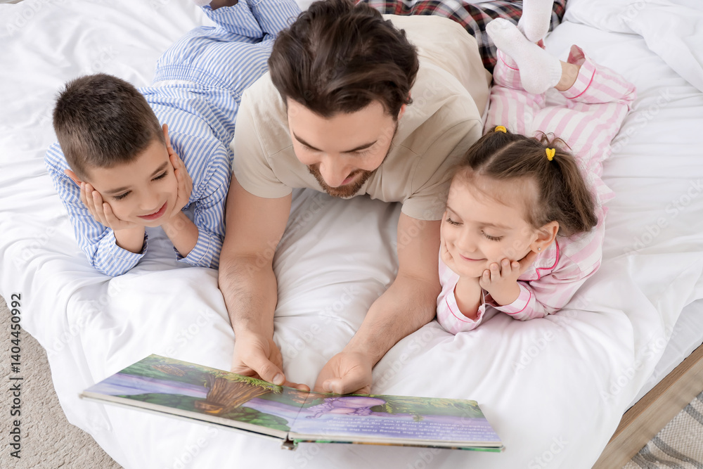 Happy father reading story to his little children in bedroom, top view Happy father reading story to his little children in bedroom, top view