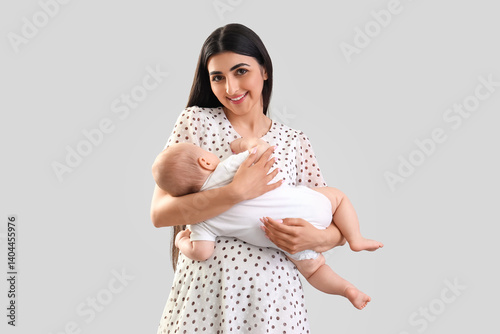 Happy mother holding her li...