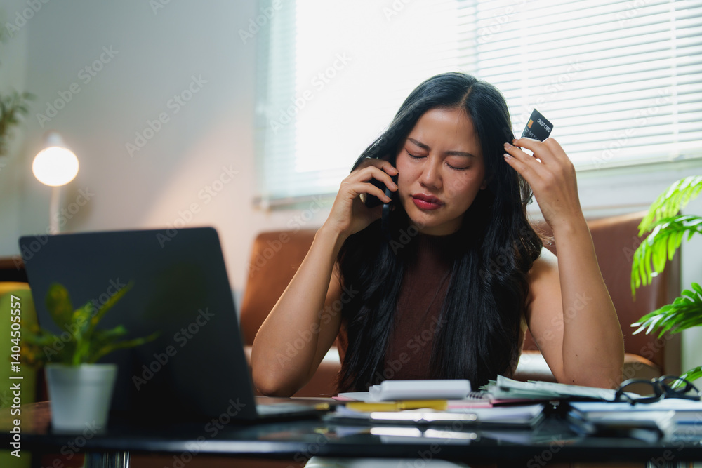 Young asian woman working from home, struggling with credit card issues while calculating bills and seeking customer service assistance, feeling stressed and confused