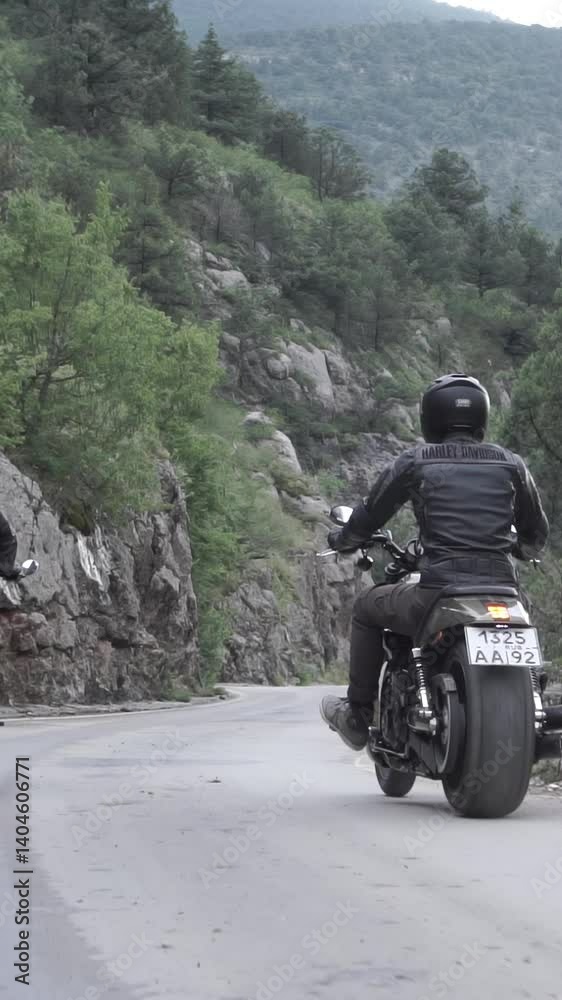 Motorcyclists drives our powerfull bikes on mountain serpentine in Monaco. Footage. Bottom View from a motorcycle. Couple of choppers with pilots in helmets descend in slow motion. Motorcyclists drives our powerfull bikes on mountain serpentine in Monaco. Footage. Bottom View from a motorcycle. Couple of choppers with pilots in helmets descend in slow motion.