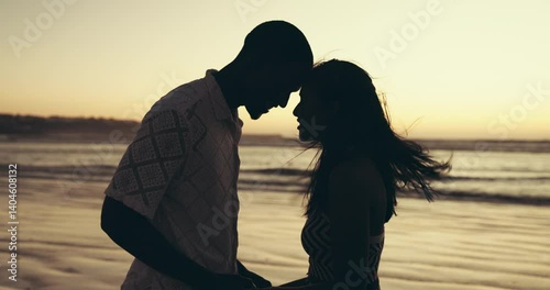 Forehead, beach and couple with love, sunset and bonding together with vacation. Ocean, people or man with woman, seaside or romance with relationship, summer holiday or silhouette on honeymoon