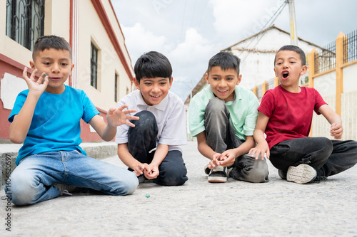 Latin american children playing marbles in the street