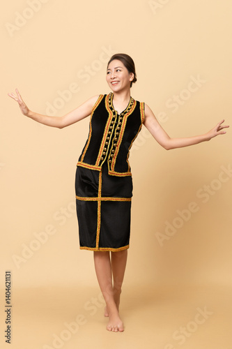 Beautiful Female Kadazandusun Native in traditional costume posing in plain background