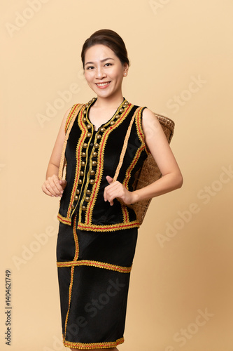 Beautiful Female Kadazandusun Native in traditional costume posing in plain background photo